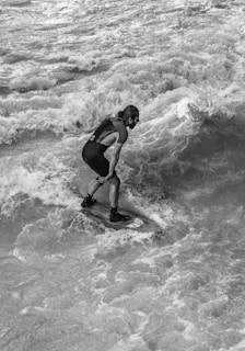 Close-up of a surfer’s focused face as they prepare to catch a wave.