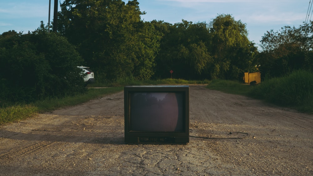 black crt tv on brown soil