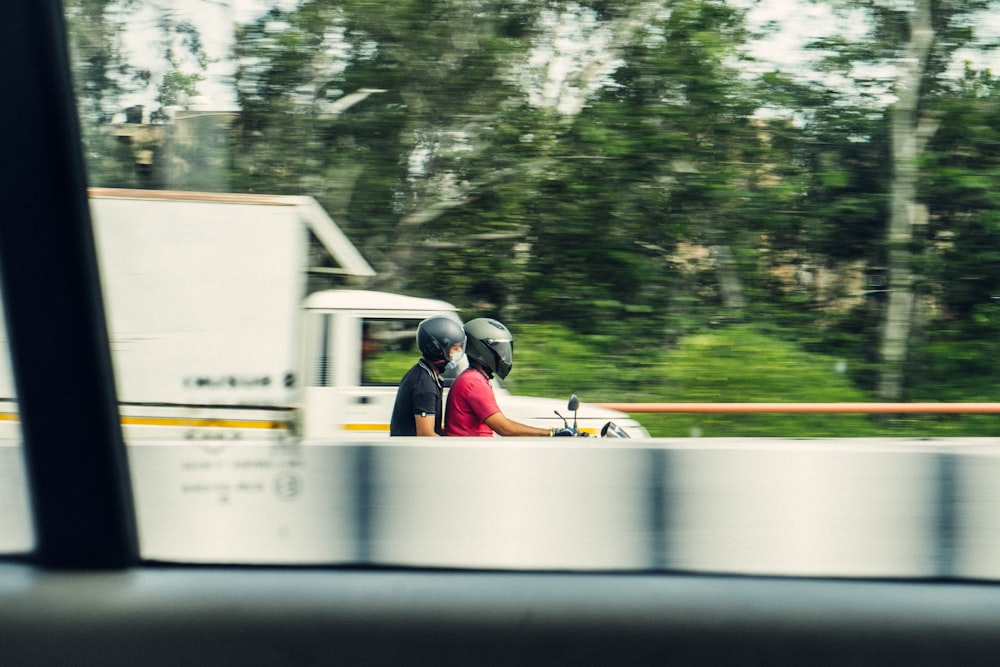 man riding motorcycle on road during daytime