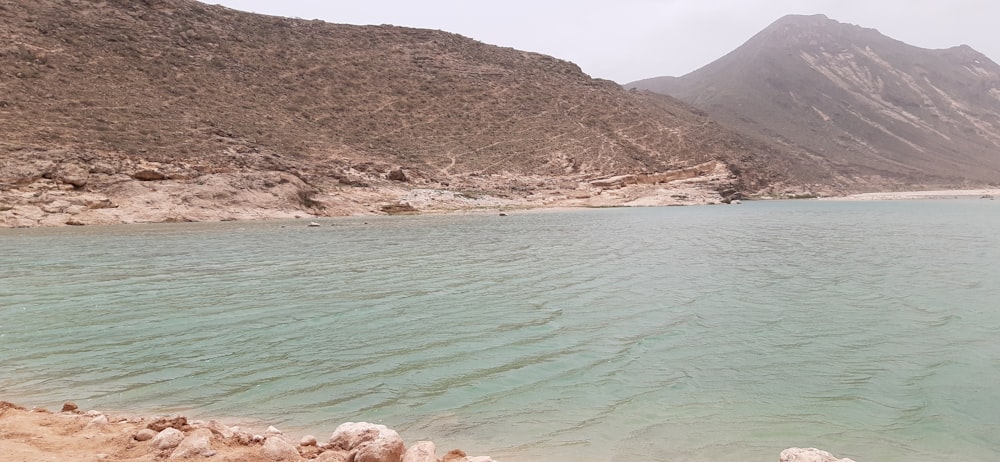 a body of water with a mountain in the background