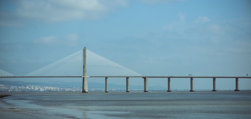 white bridge over the sea during daytime