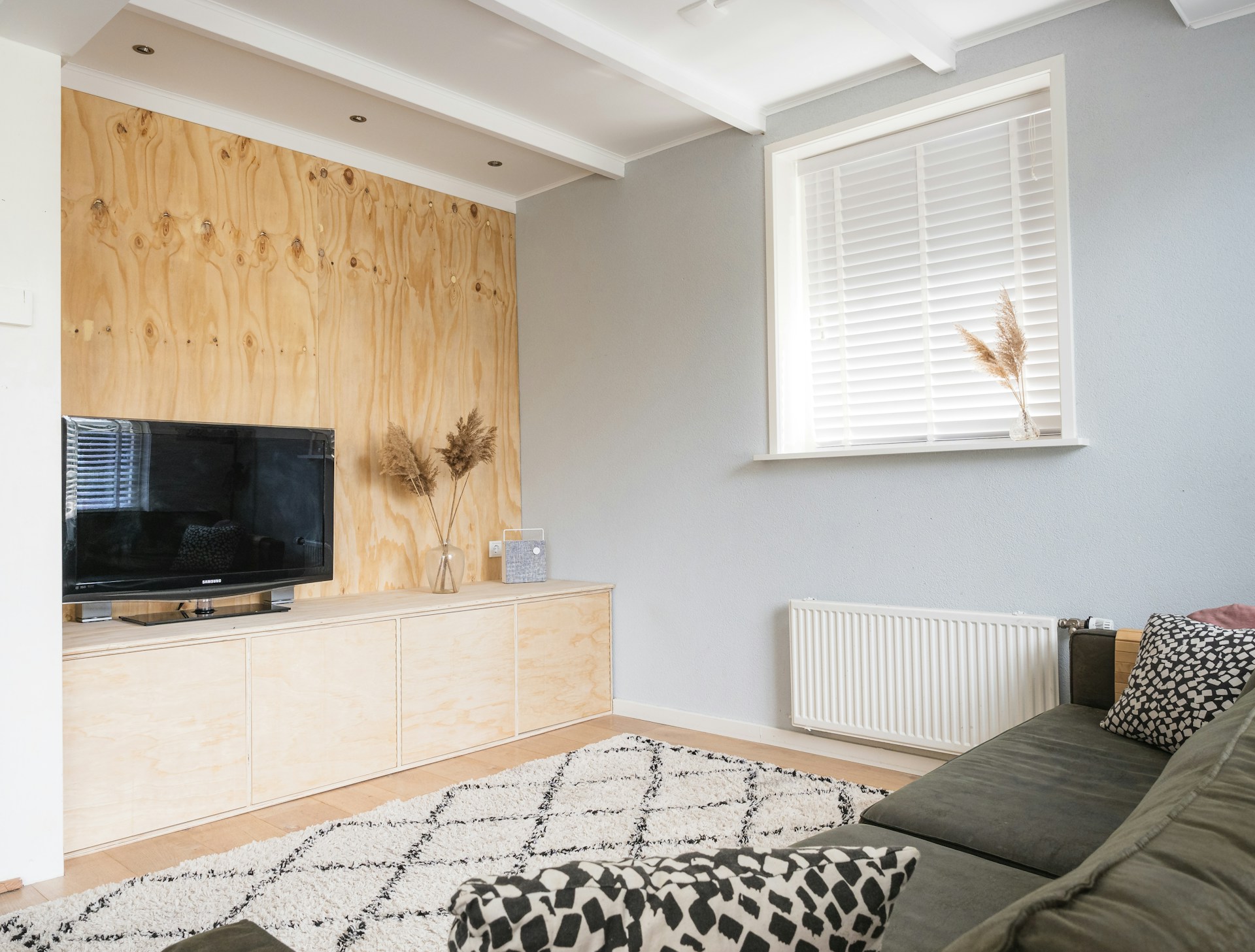 black flat screen tv on brown wooden tv rack