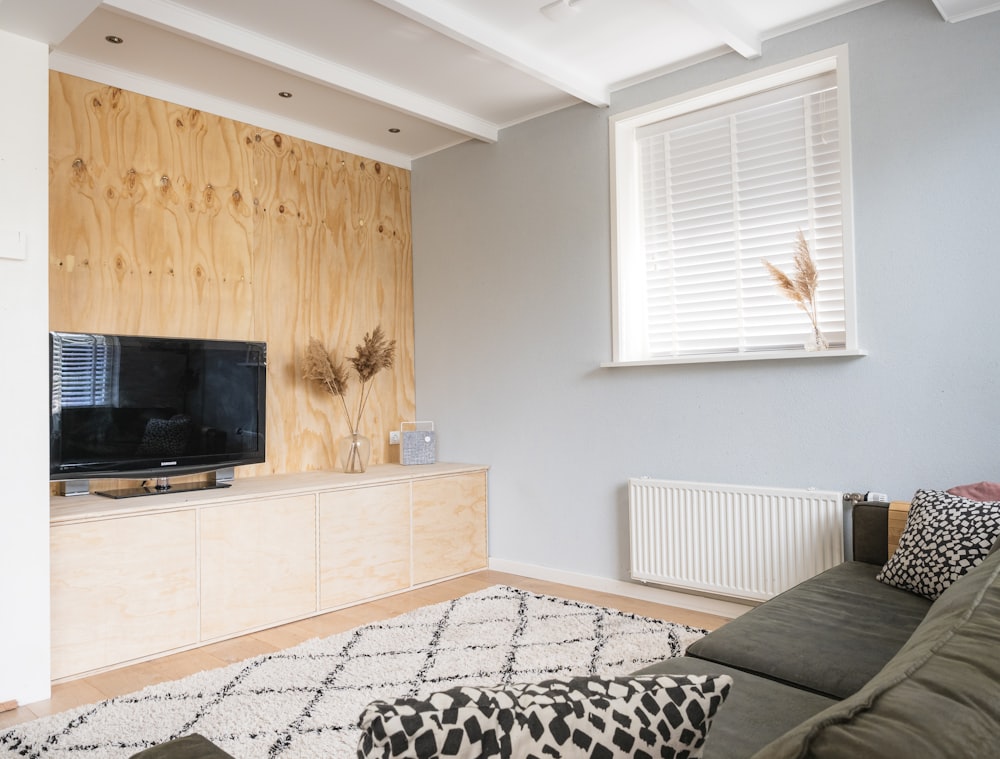 black flat screen tv on brown wooden tv rack