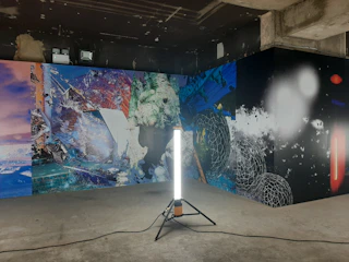 A cozy modern room with framed abstract digital art pieces hanging on the wall, blending retro colors and fresh design.