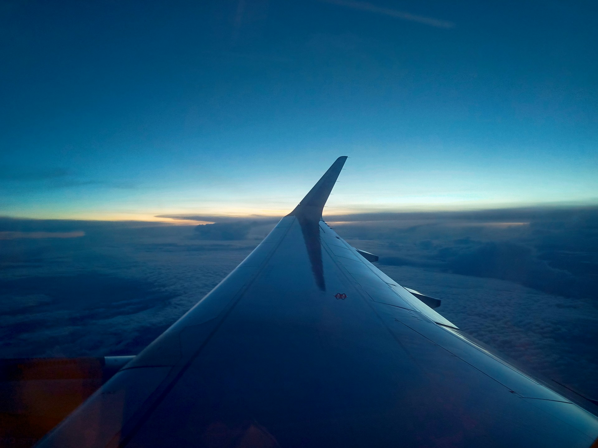 airplane wing over the clouds during daytime