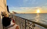 A cozy seaside apartment complex with balconies overlooking the Black Sea at sunset