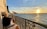 A cozy balcony overlooking a scenic view of Dieppe's coastline at sunset.