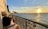 A cozy balcony overlooking a scenic view of Dieppe's coastline at sunset.