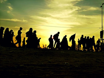 A group of neighbors activating a solar-powered community alarm together at sunset.