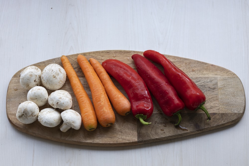 orange carrots on brown wooden chopping board