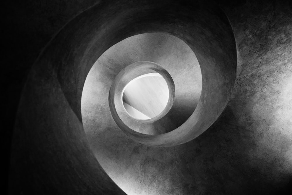 grayscale photo of spiral tunnel