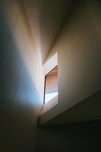 white concrete wall with brown wooden door
