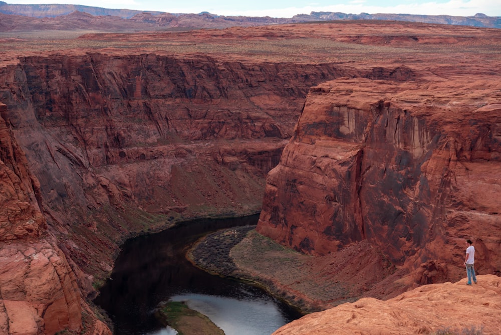 brown rock formation near body of water during daytime