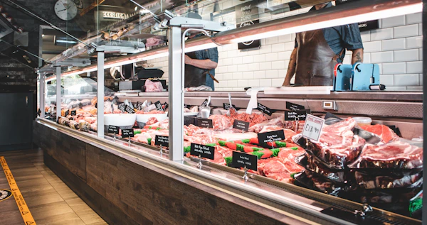 Fresh cuts of meat displayed in a butcher's meat counter case