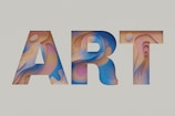 Bold letters 'A', 'R', and 'T' with intricate patterns and textures fill the space. The design employs fluid, abstract shapes and transitions of color within each letter, creating a layered and three-dimensional effect on a muted background.