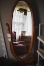 brown wooden framed pink padded armchair