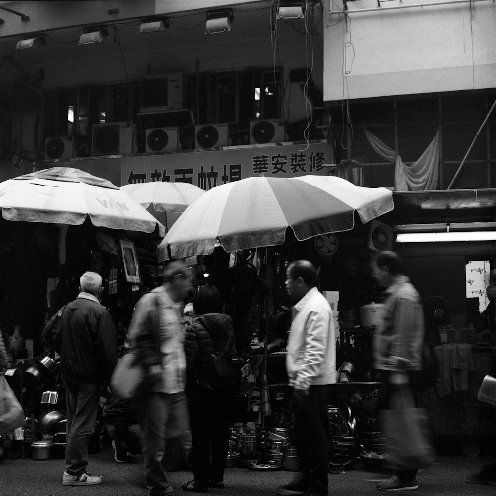 grayscale photo of people walking on street