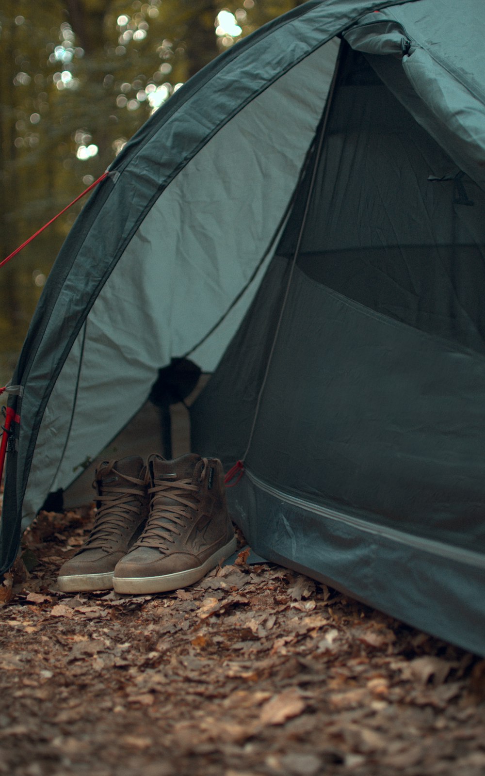 person in black pants in gray tent