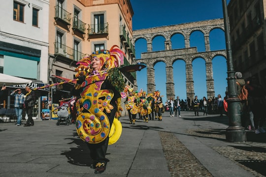 yellow and black mickey mouse balloon in Aqueduct of Segovia Spain