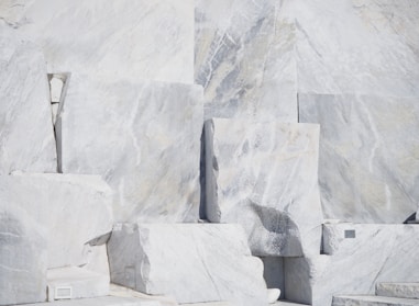 Rough marble blocks stacked in a sunlit warehouse