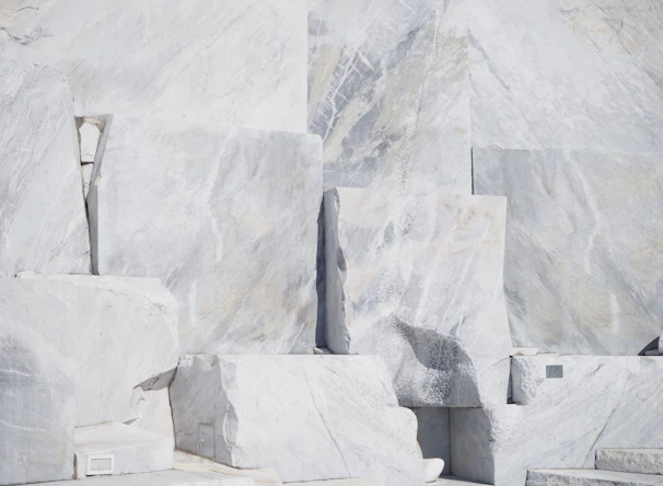 Close-up image of pristine white Makrana marble slabs stacked neatly, showcasing their fine texture and natural veins