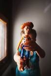 person holding brown and blue plastic toy