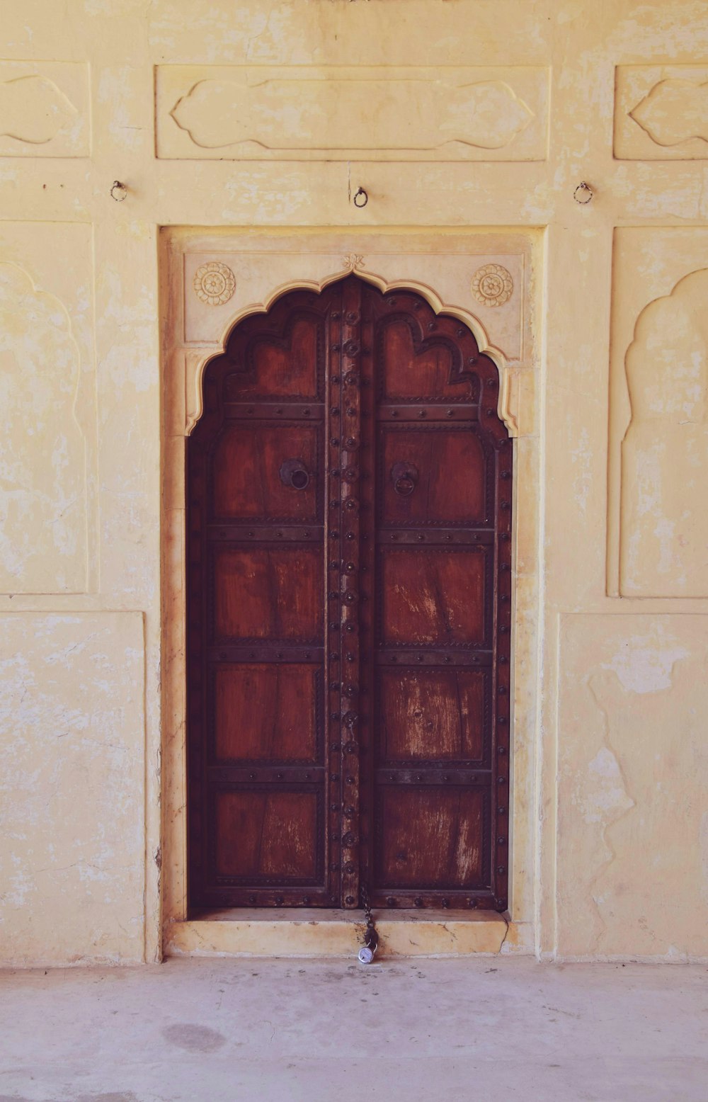 brown wooden door on white wall