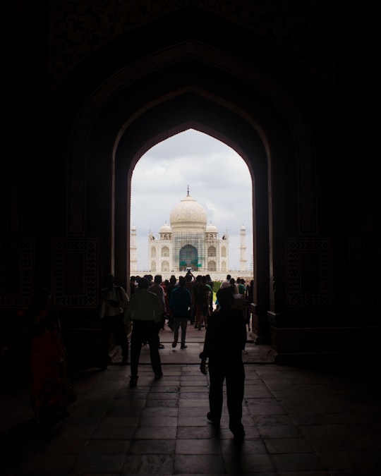 people walking inside dome building in Taj Mahal India