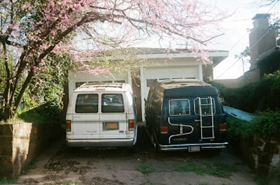 white van parked beside pink cherry blossom tree