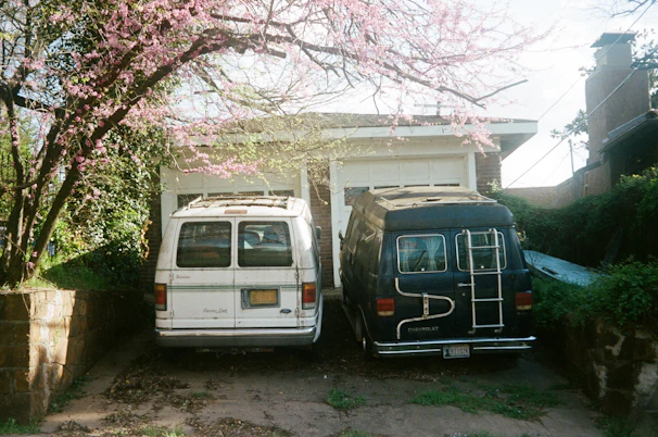 A close-up of a Swiftvan Movers van parked outside a cozy suburban house.