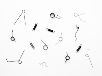 silver safety pin on white surface