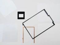 A minimalist display of modern, geometric frames on a clean white background.