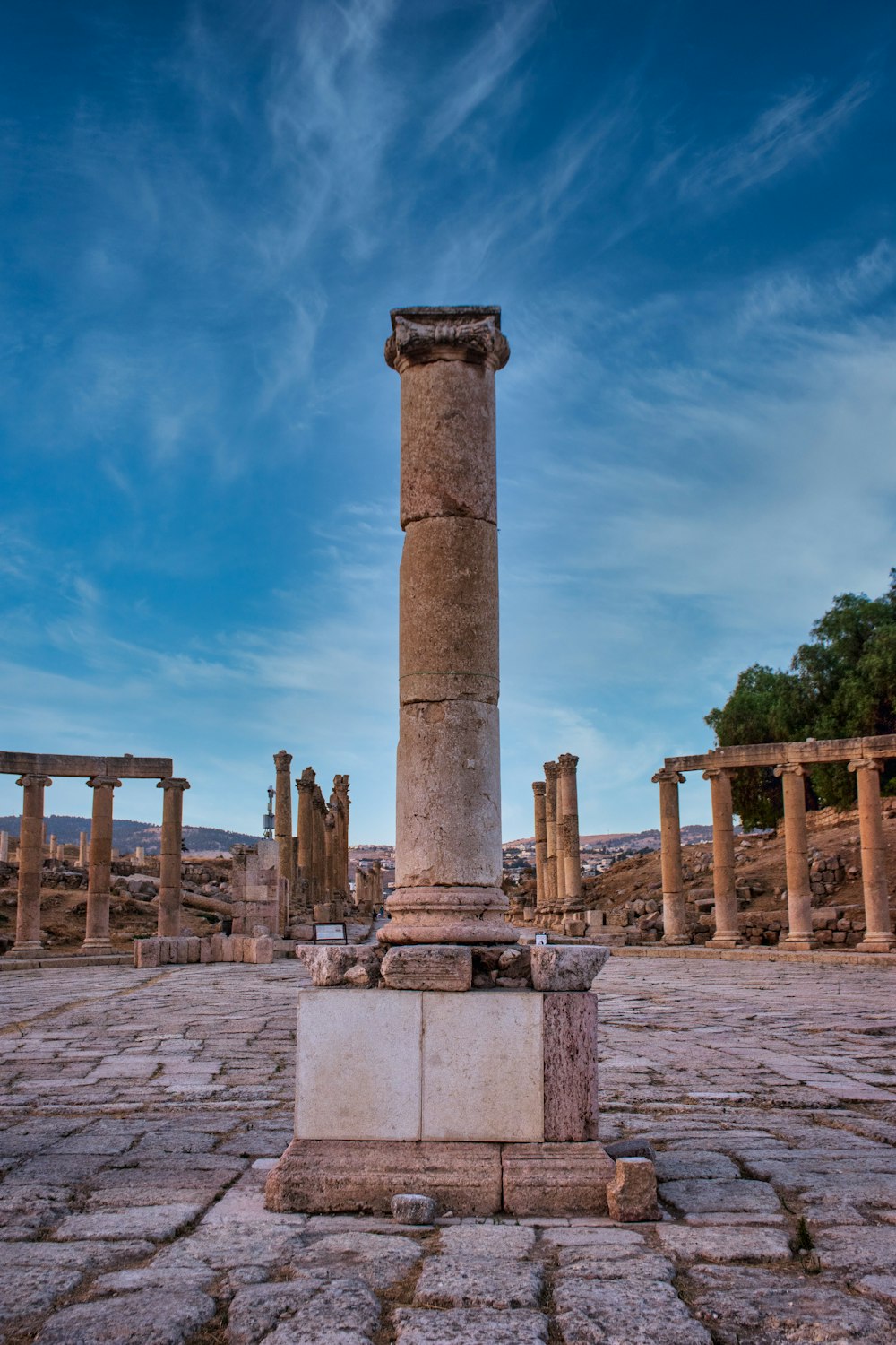 brown concrete pillar near body of water during daytime