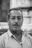 grayscale photo of man in striped shirt