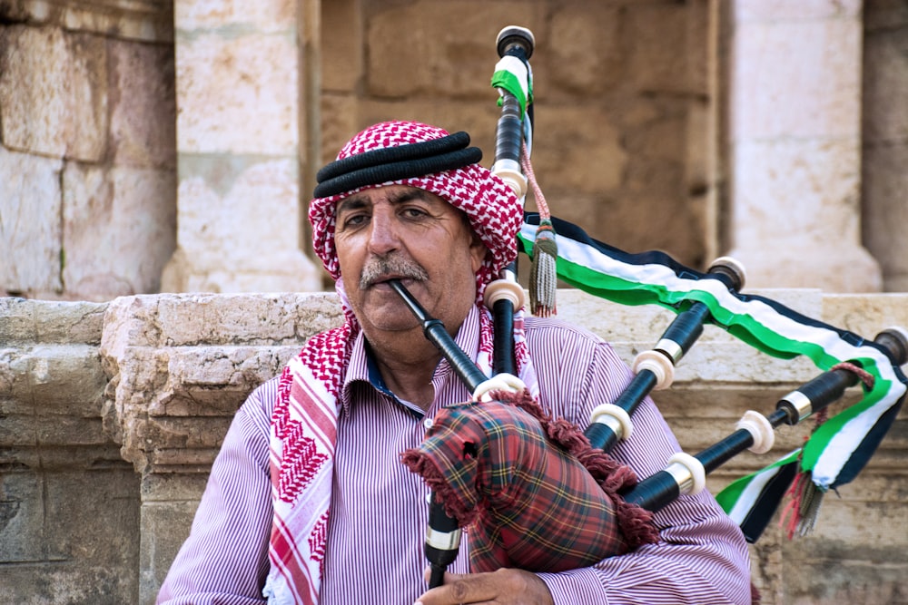 man in red and white stripe long sleeve shirt playing flute