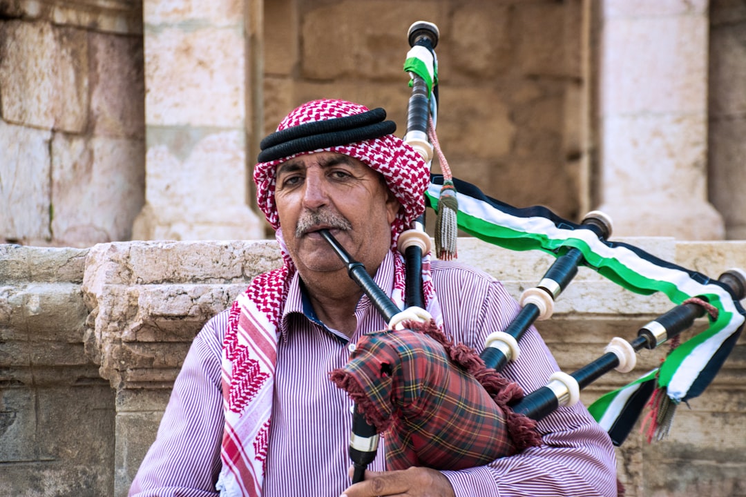 man in red and white stripe long sleeve shirt playing flute,