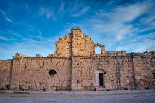 brown concrete building under blue sky during daytime in Jerash Jordan