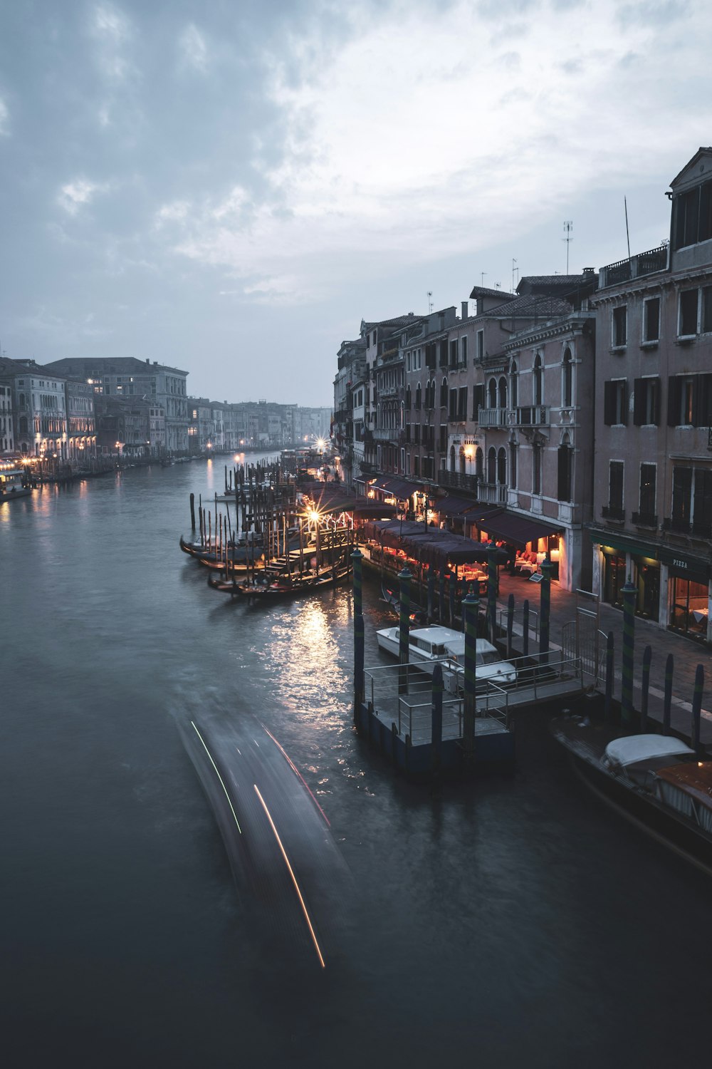 boat on river between buildings during daytime