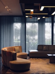 A modern living room with smart lighting and automated window shades.