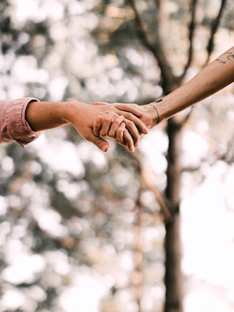 person holding hands with white clouds