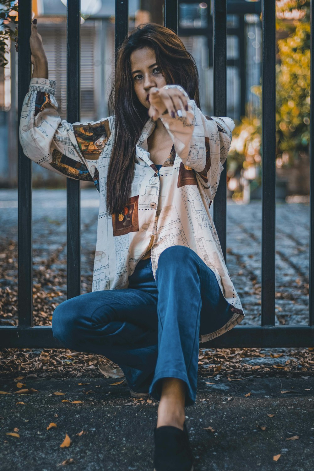 Woman in blue denim jacket and blue denim jeans sitting on brown wooden  bench during daytime photo – Free Street Image on Unsplash