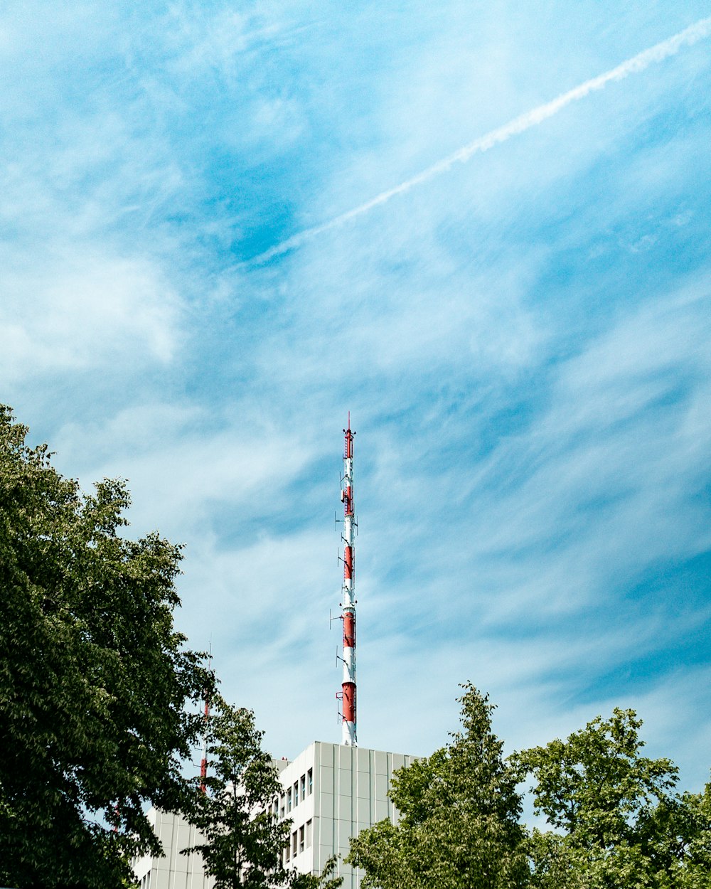 white and red tower under blue sky