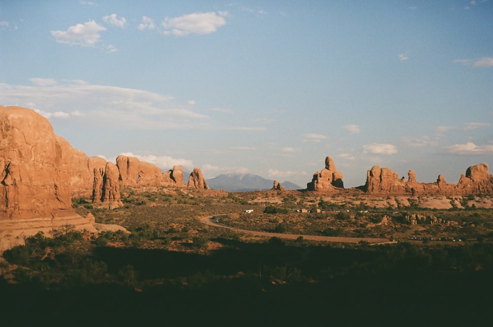 people walking on brown rock formation during daytime