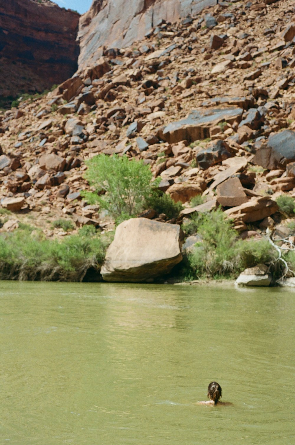 brown rock formation beside body of water during daytime