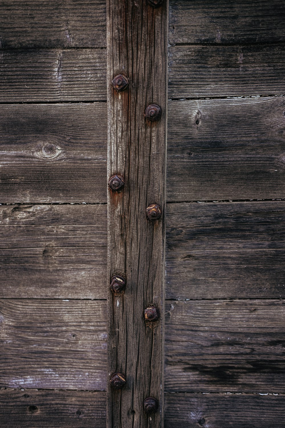 brown wooden door with black steel door handle