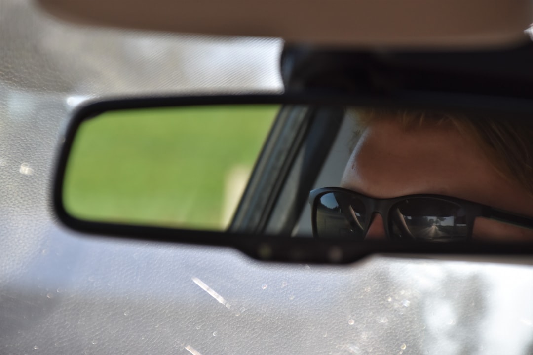 car side mirror with reflection of car