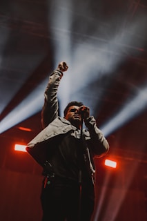 A close-up of a musician performing passionately on stage.