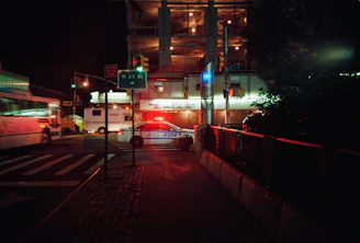 Emergency glass replacement being done at night on a busy NYC street.