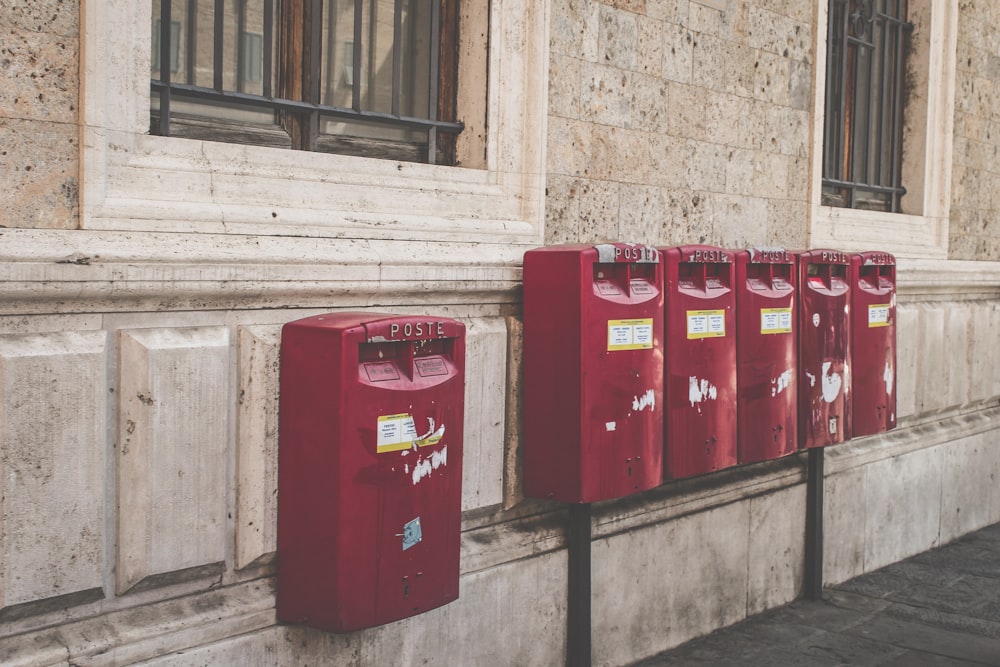 red and black metal trash bins