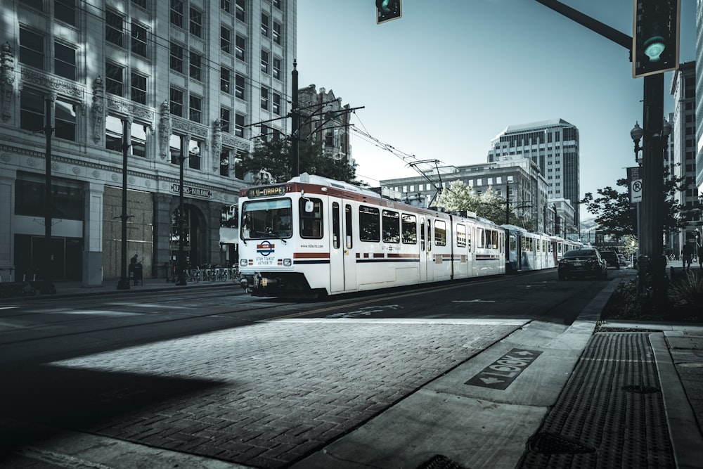 white and red tram on road during daytime